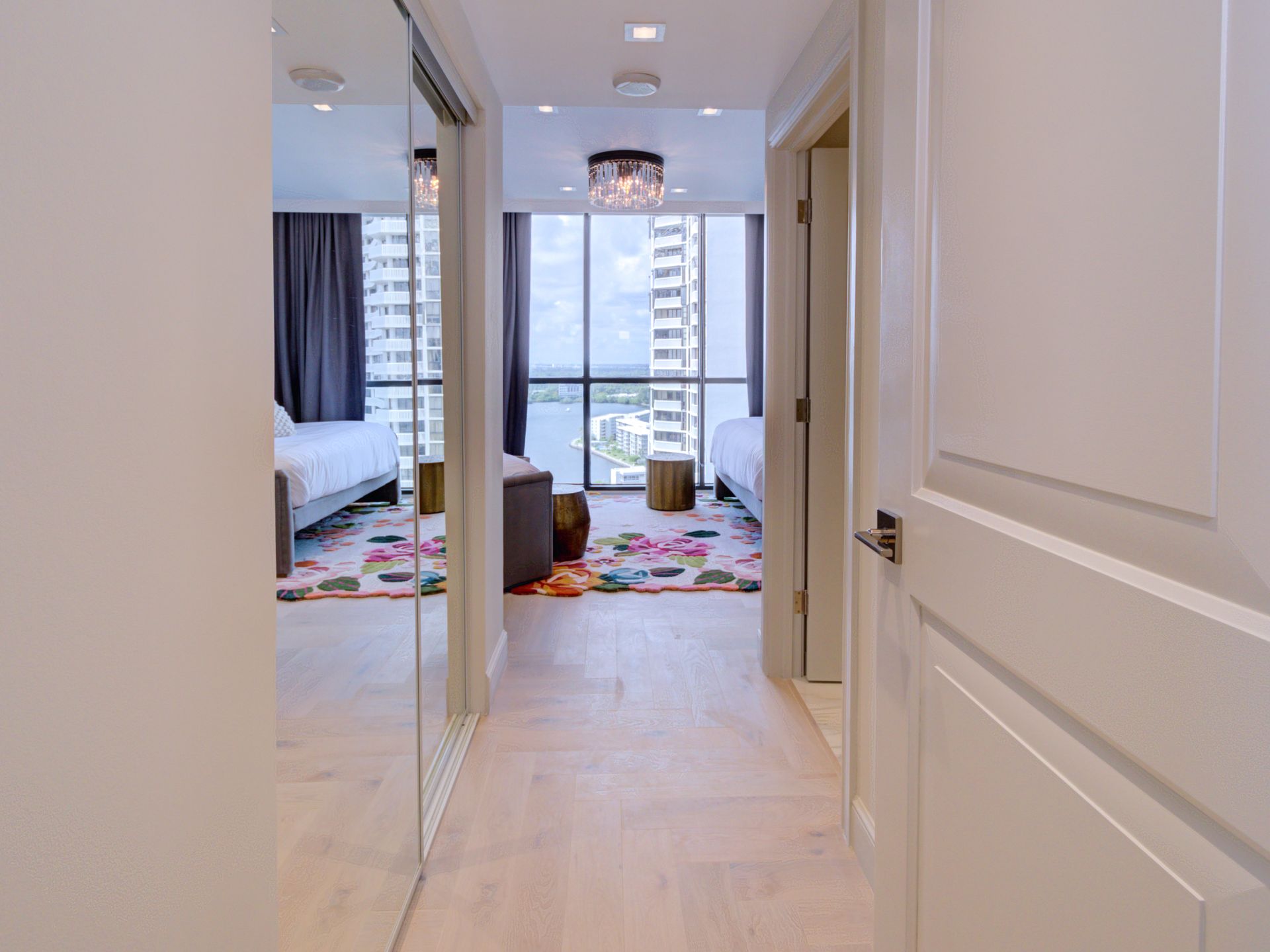 A hallway leading to a bedroom with a view of the ocean.