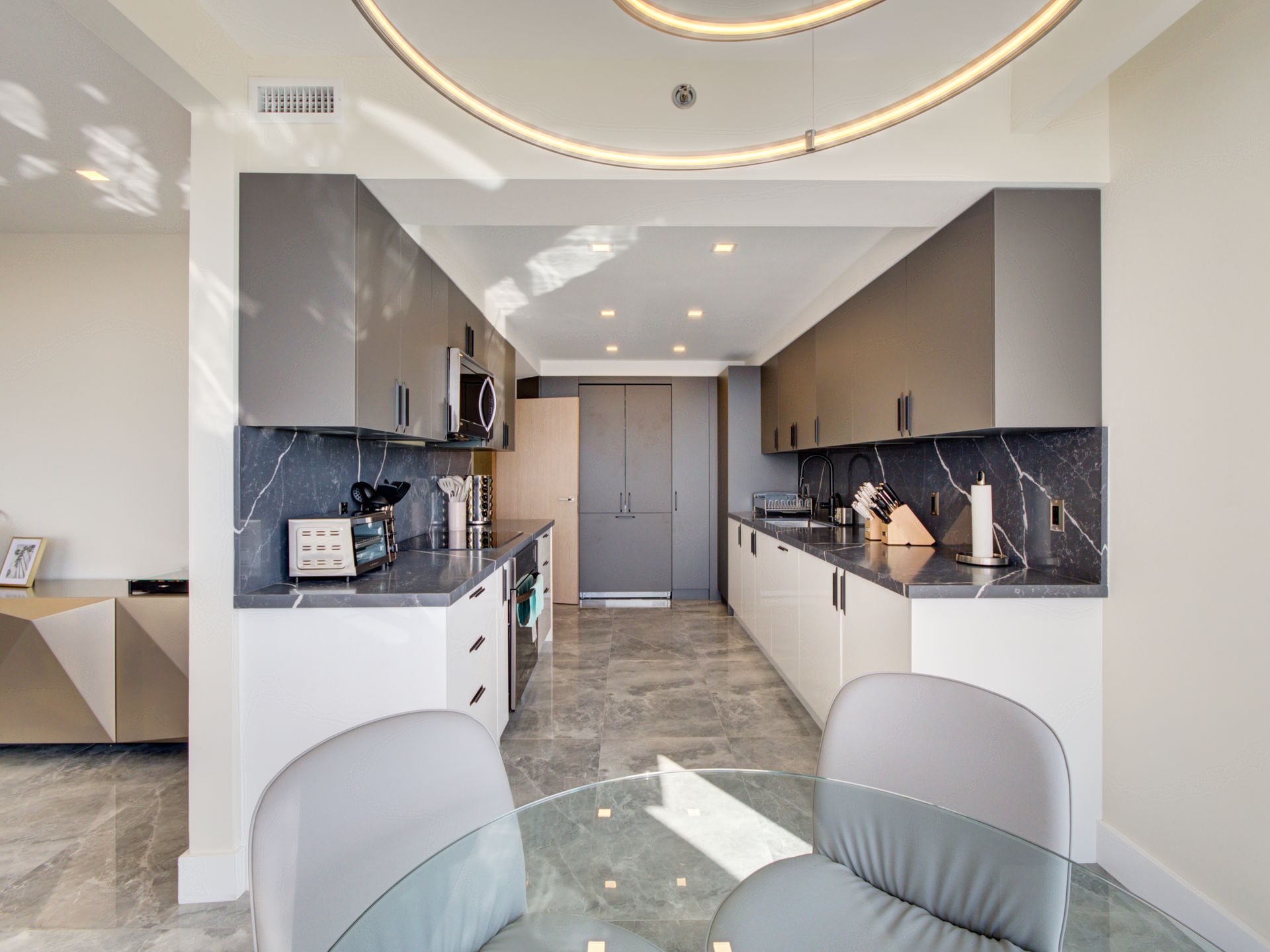 A kitchen with a table and chairs in it