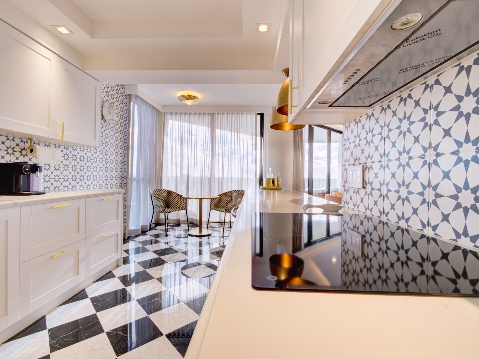 A kitchen with a black and white checkered floor and a stove top oven.