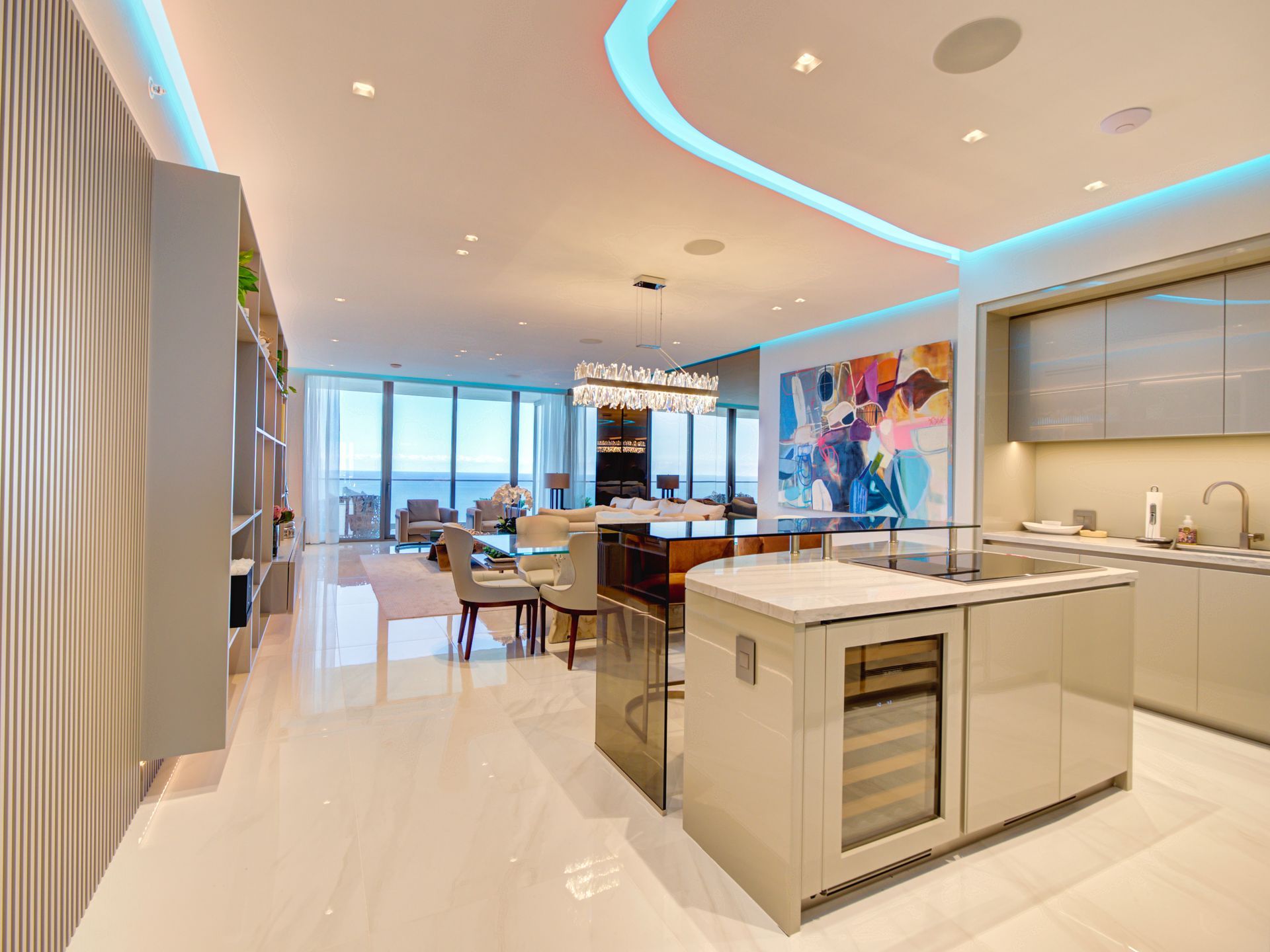 A kitchen with a large island and a dining room in the background.