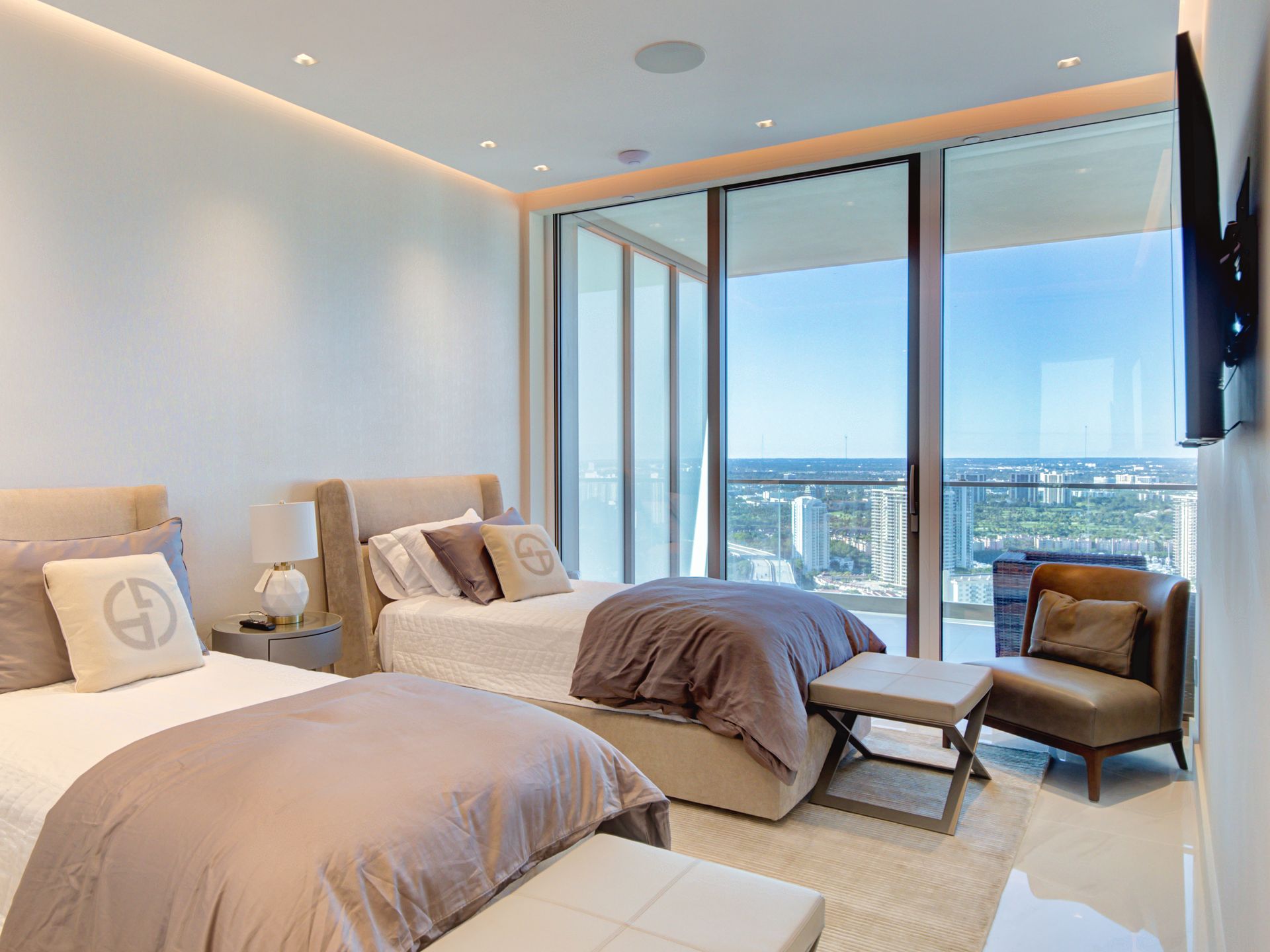 A bedroom with two beds and a flat screen tv