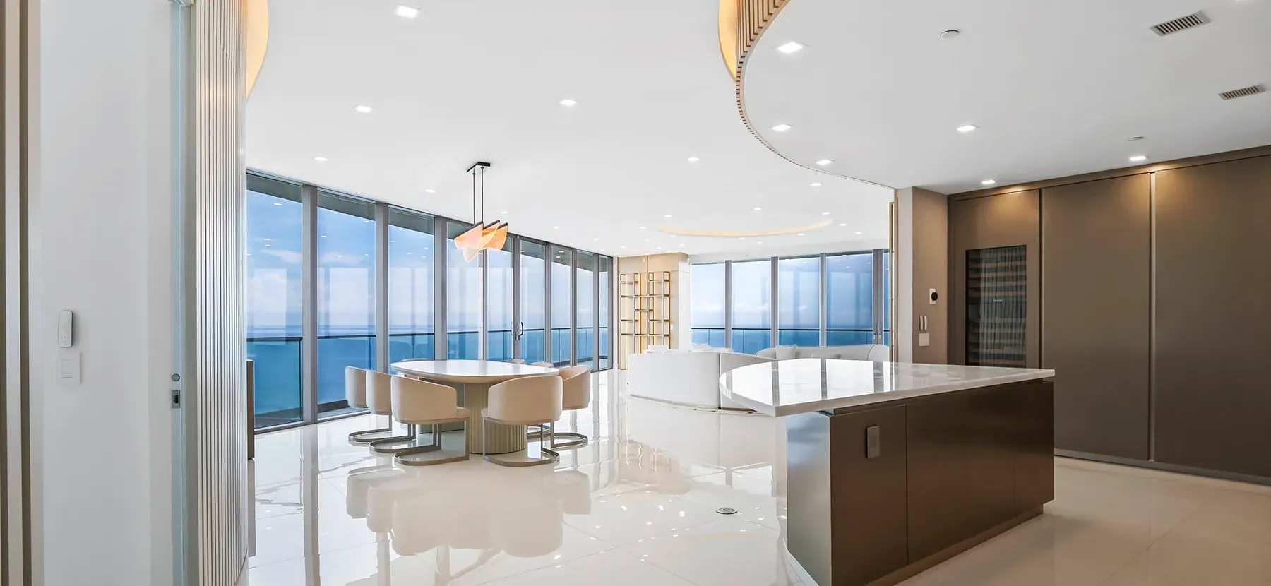 A large room with a lot of windows and a table and chairs in it.