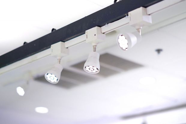 A close up of a row of lights hanging from the ceiling.