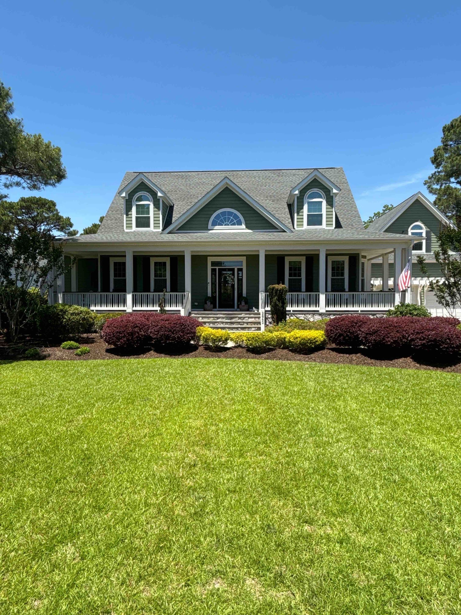 A large house with a large lawn in front of it.