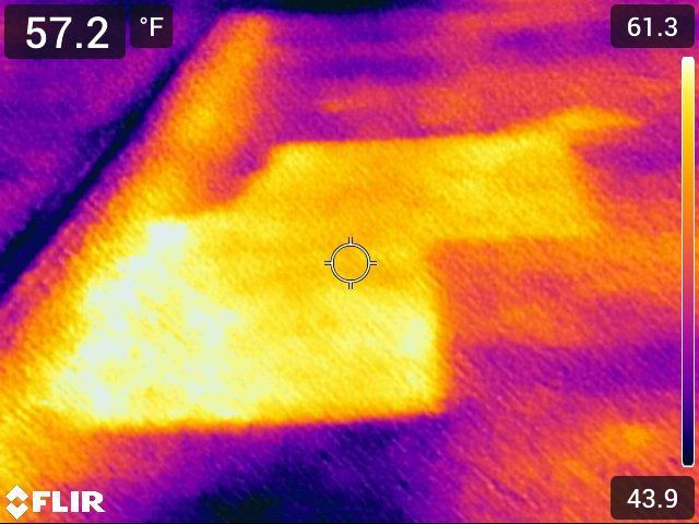Thermal image of a surface showing a warm spot (yellow/orange) against cooler areas (purple/blue). Temperature range: 43.9-61.3°F.