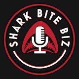 The logo for shark bite biz is a microphone with a shark on it.