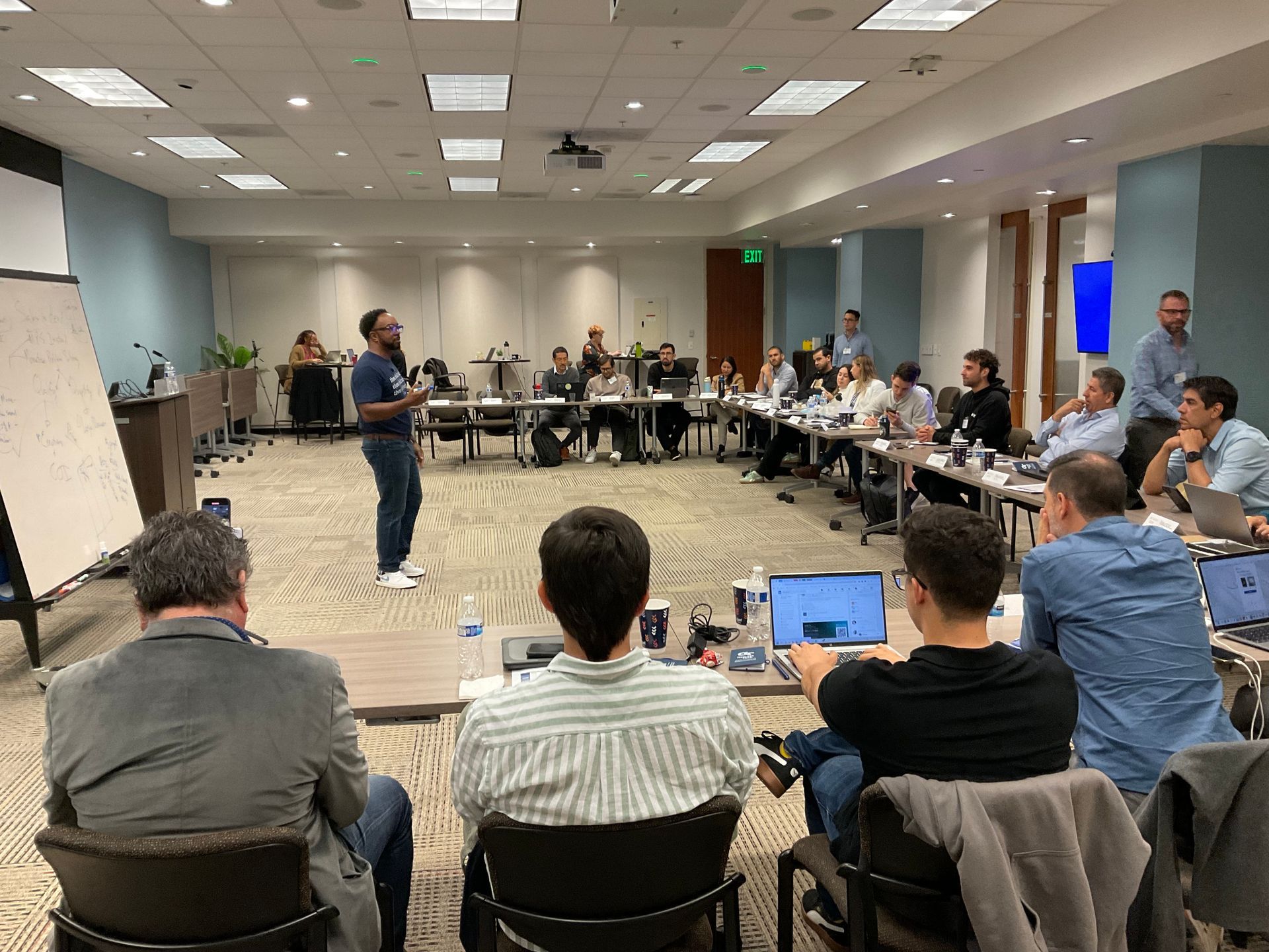Kirk is giving a presentation to a group of people in a conference room.