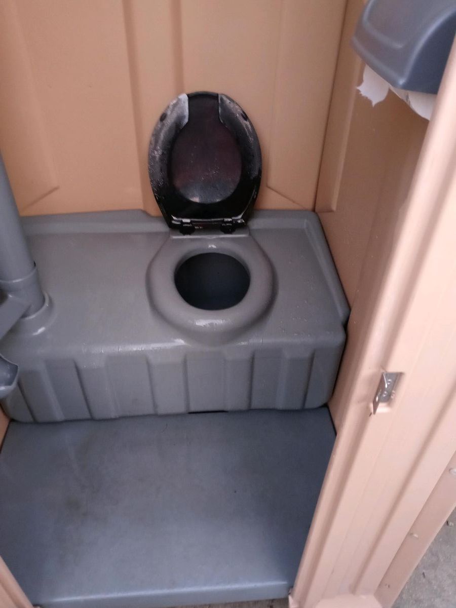 A close up of a toilet with the lid open