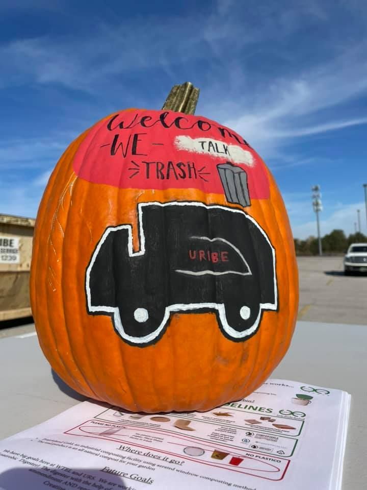 A pumpkin with a trash truck painted on it
