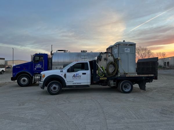 Two trucks are parked next to each other in a parking lot.
