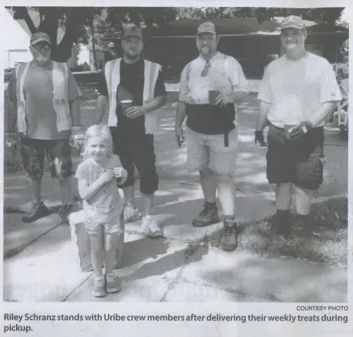 Riley schenz stands with uribe crew members after delivering their weekly treats during pickup
