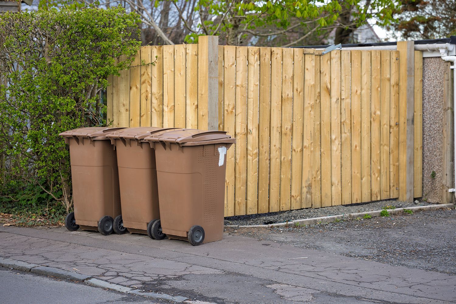 Three brown wheelie bins
