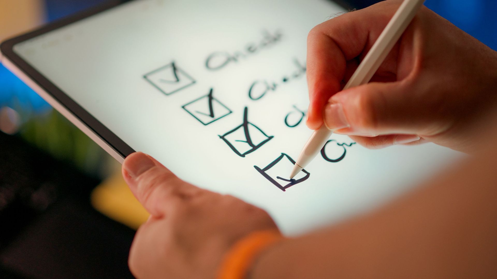 Hand checking off items on a white digital checklist with a stylus
