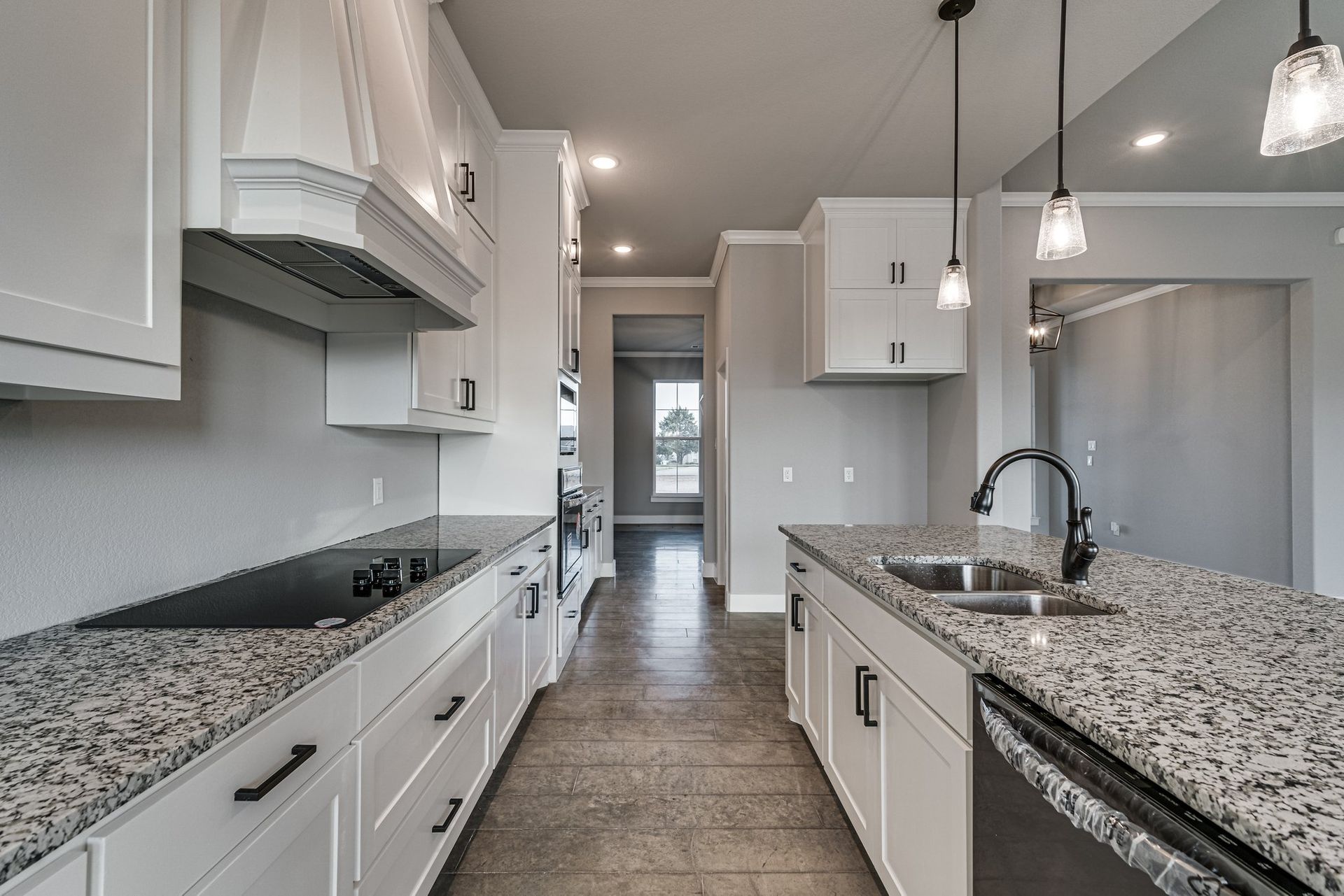 modern kitchen with white cabinetry and granite countertops