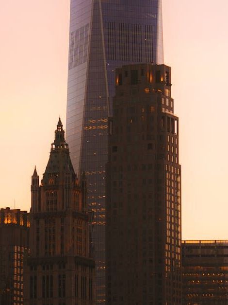 A city skyline with a tall building in the foreground