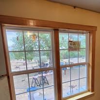 Two-pane window with wooden trim, showing an outdoor view through the glass.