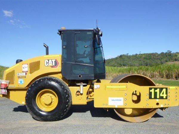 A yellow cat roller with the number 114 on it