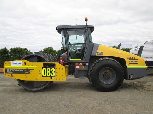 A yellow tractor with the number 083 on it