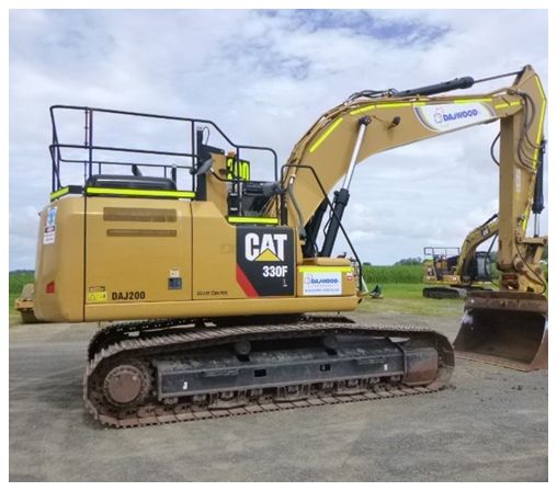 A large cat excavator is parked in a parking lot.