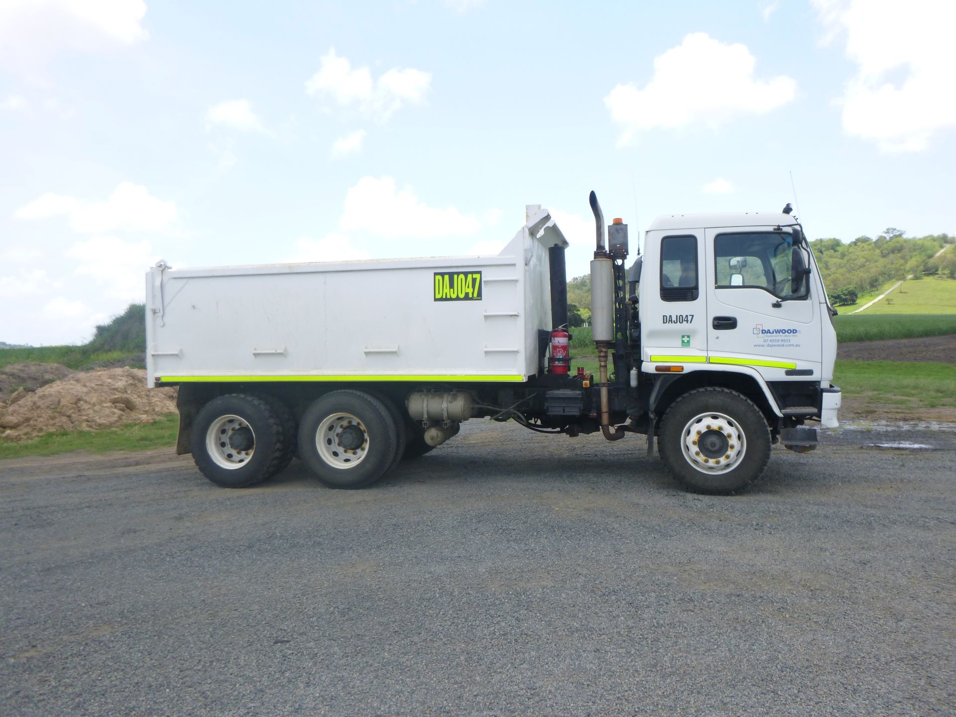 A white truck with a yellow sticker on the side that says dajo81