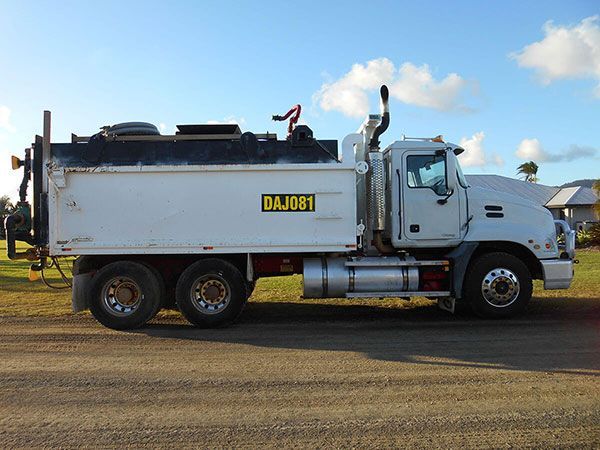 A white dump truck with bajabi written on the side