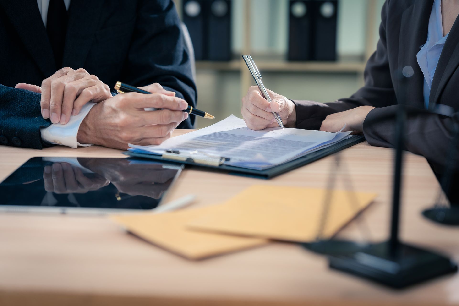 Trusts lawyer meeting with a client to review and sign trust documents. Trusts lawyer meeting with a client to review and sign trust documents.