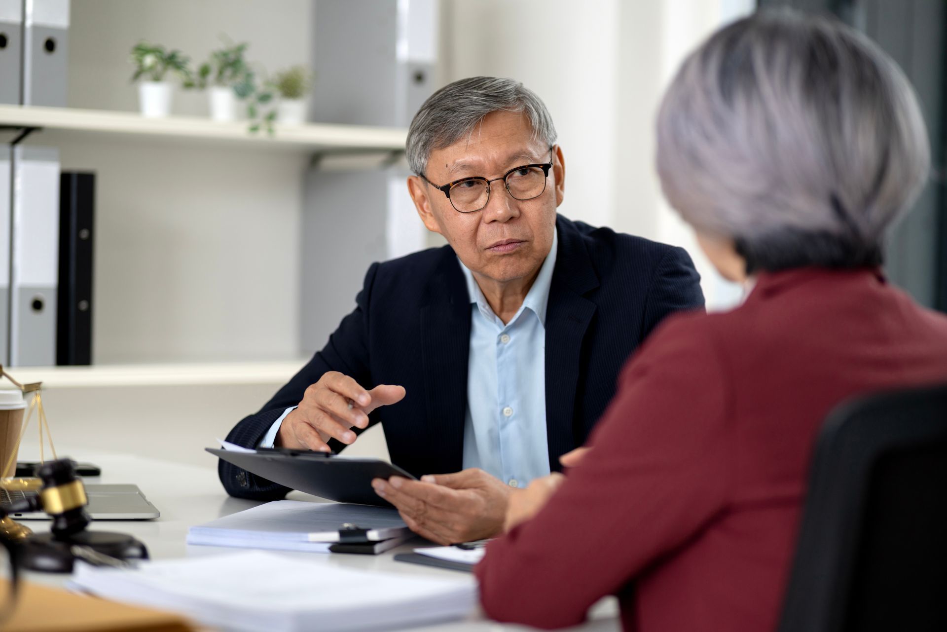 A lawyer is talking to an elderly woman. A lawyer is talking to an elderly woman.