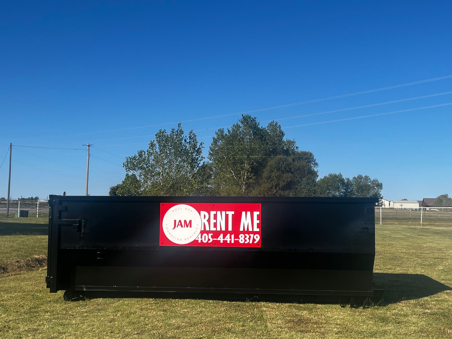 A dumpster with a red sign that says rent me