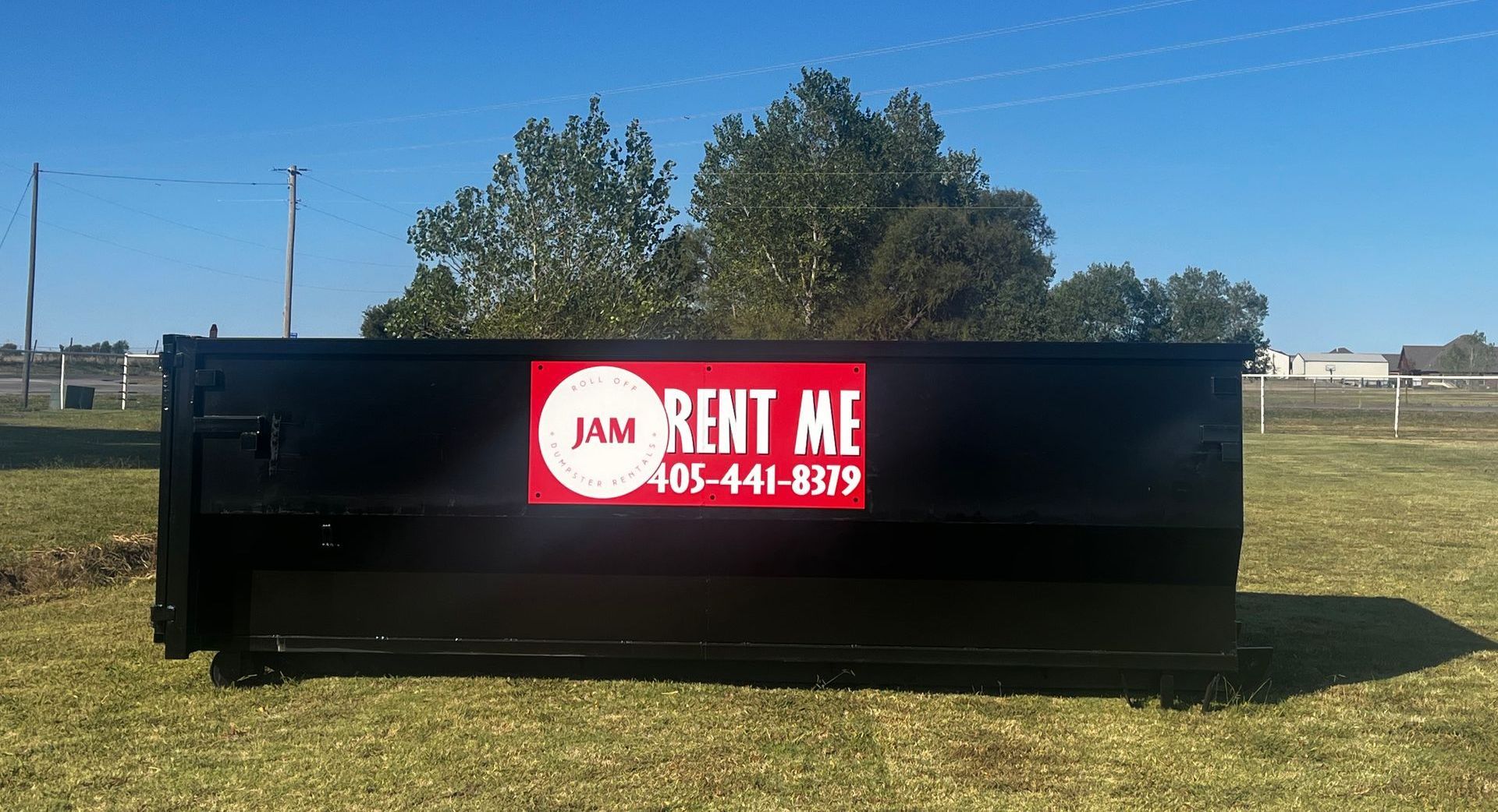 A dumpster with a red sign that says rent me