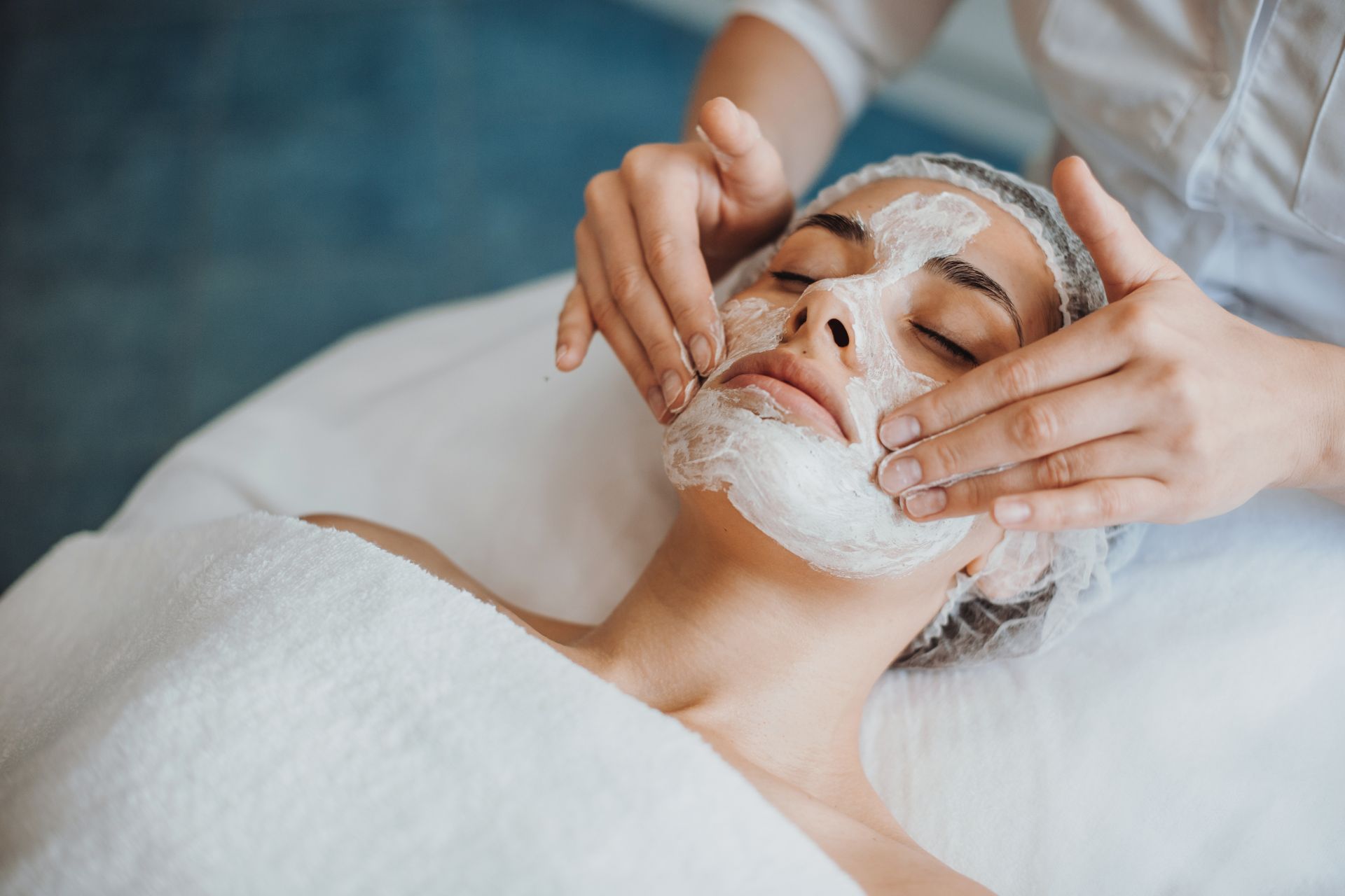 Spa facial treatment with white cleansing foam applied to a client’s face