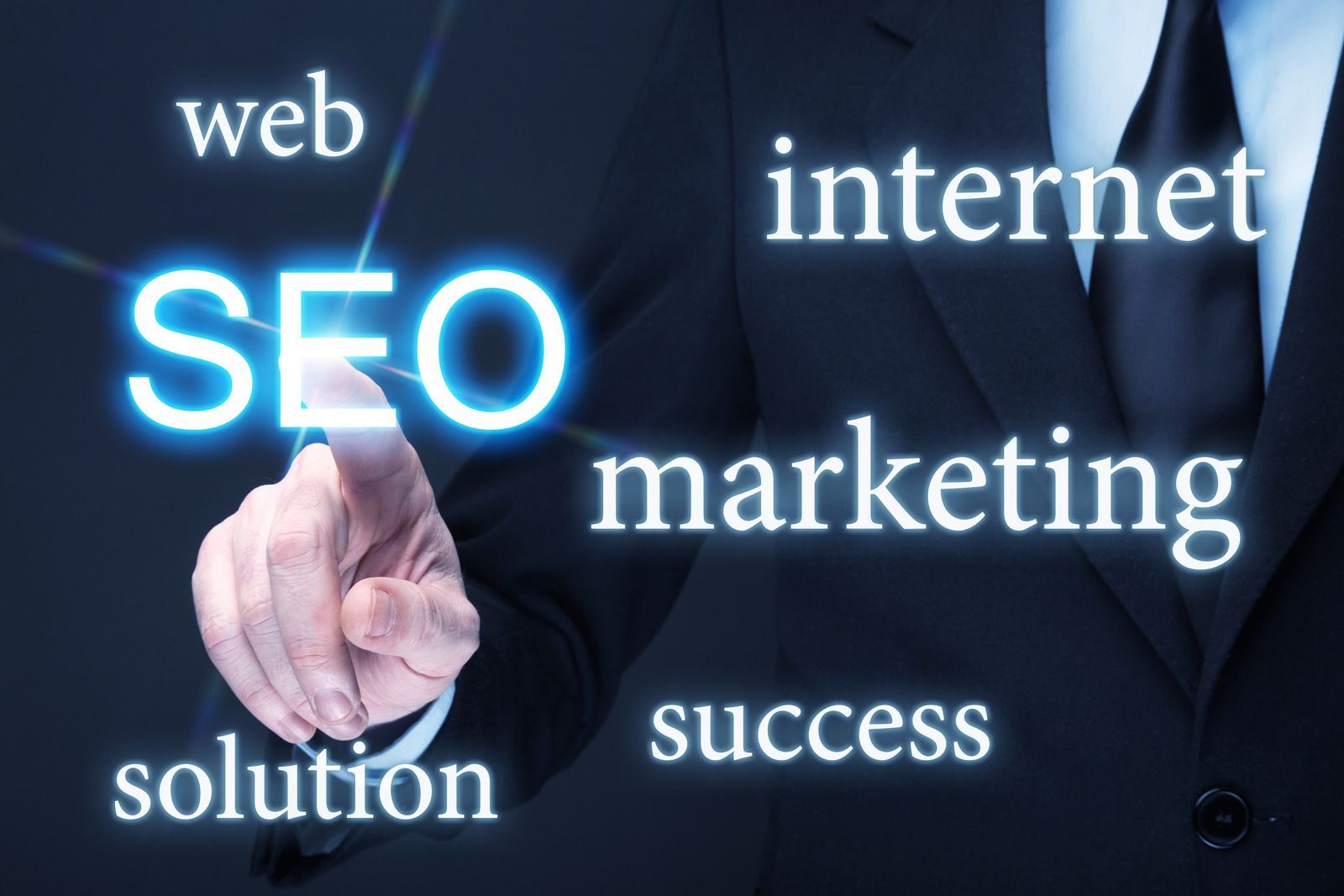 A man in a suit is pointing at the word seo