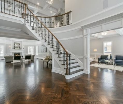 A large house with a curved staircase leading up to the second floor.