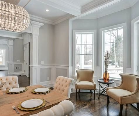 A dining room with a table and chairs and a chandelier