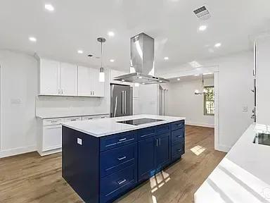There is a large island in the middle of the kitchen.