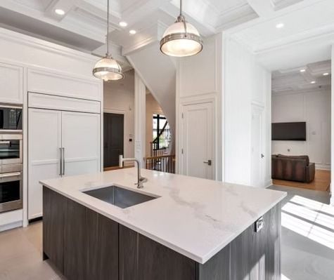 A kitchen with a large island and a sink.