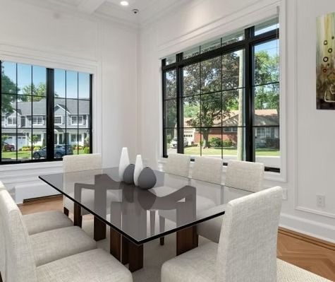 A dining room with a glass table and white chairs