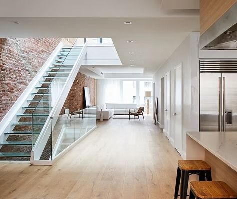 A living room with a staircase leading up to the second floor