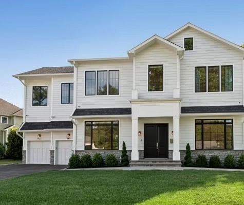 A large white house with a black door and windows