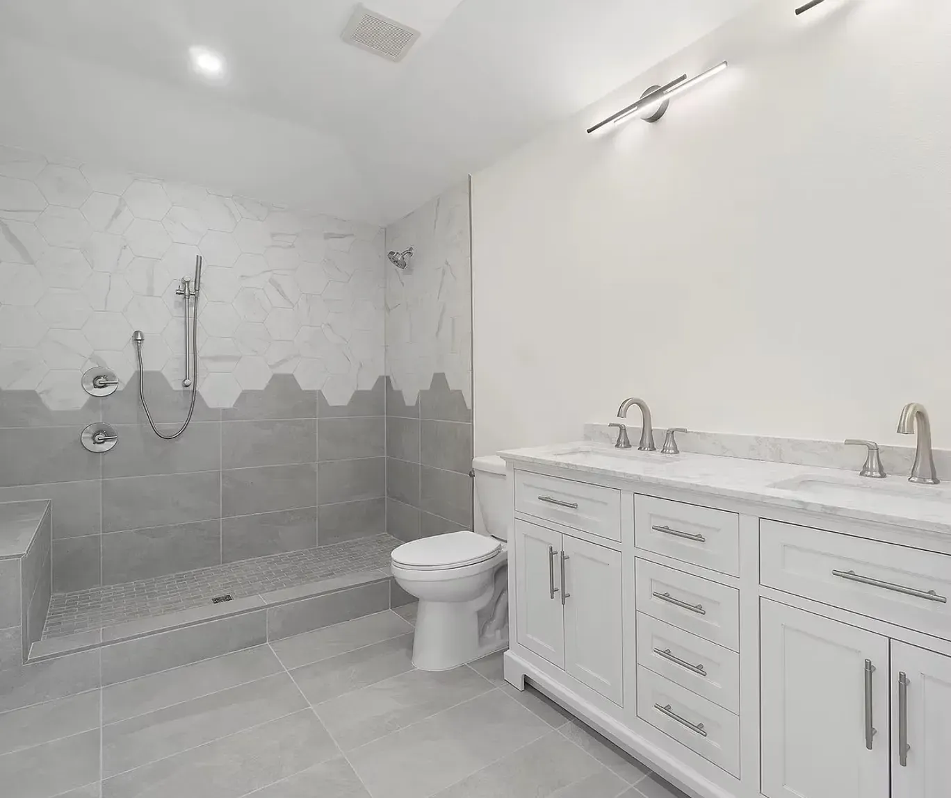 A bathroom with a toilet , sink , and shower.
