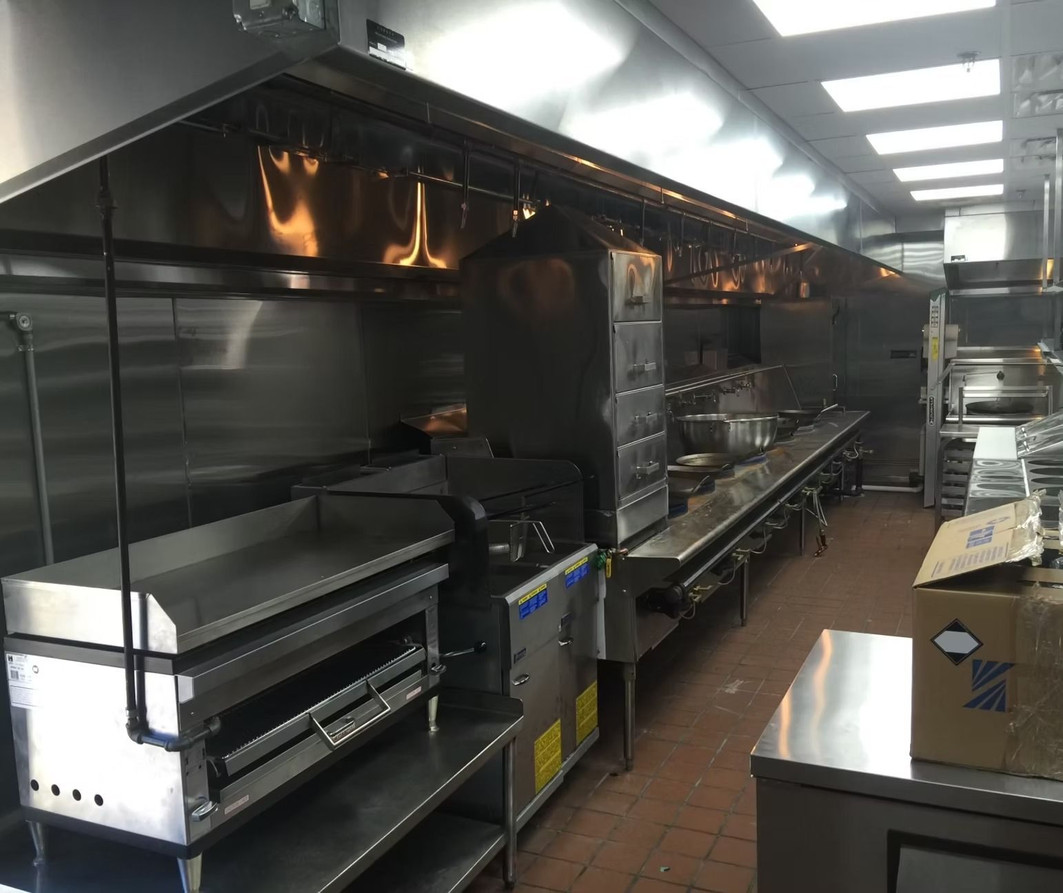 A large kitchen with a lot of stainless steel appliances