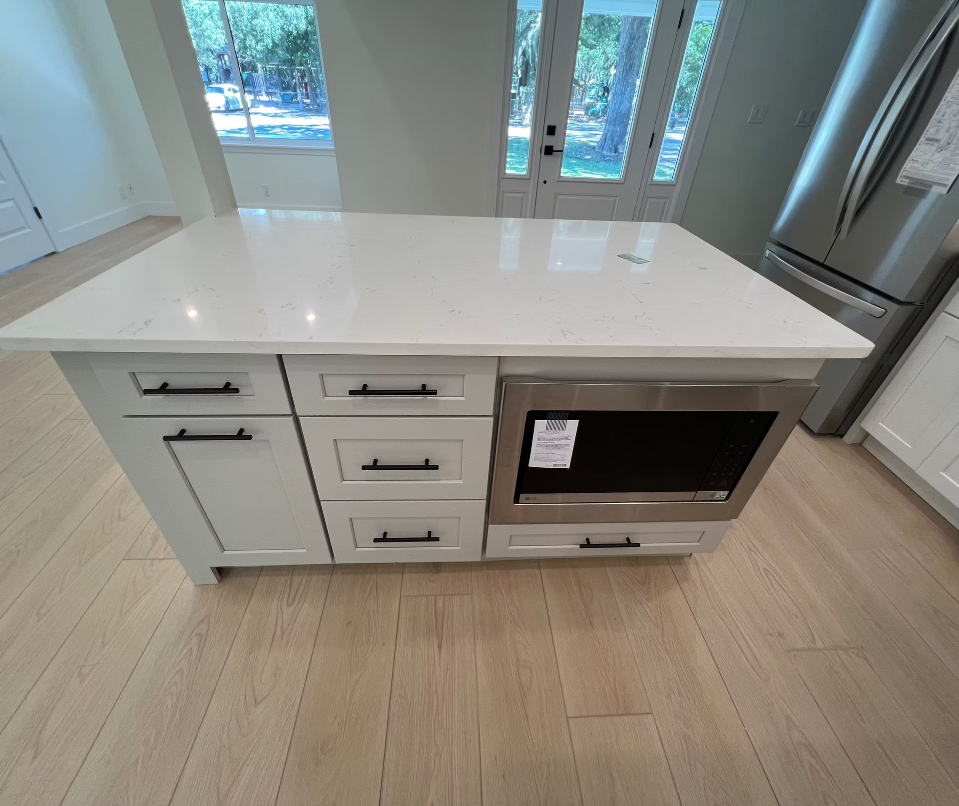 A kitchen with a large island and stainless steel appliances