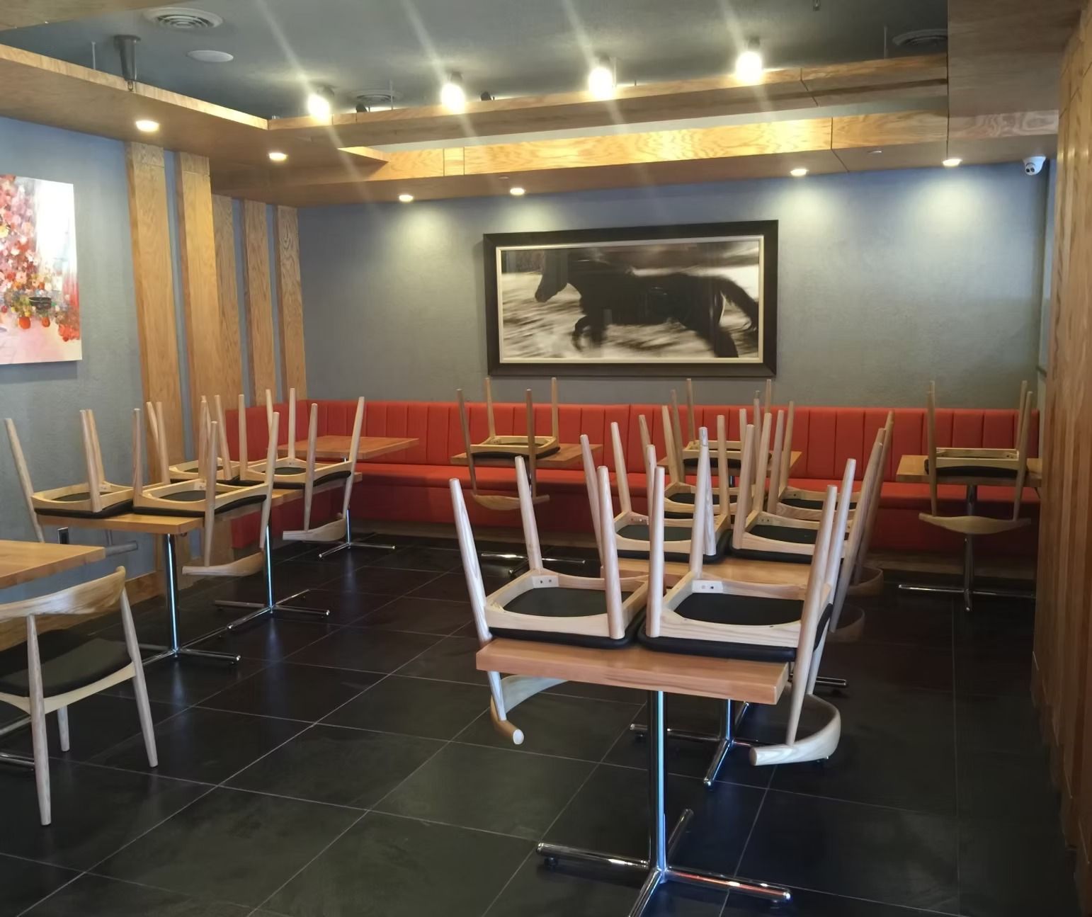 A restaurant with tables and chairs stacked on top of each other