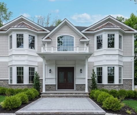 A large house with a lot of windows and stairs