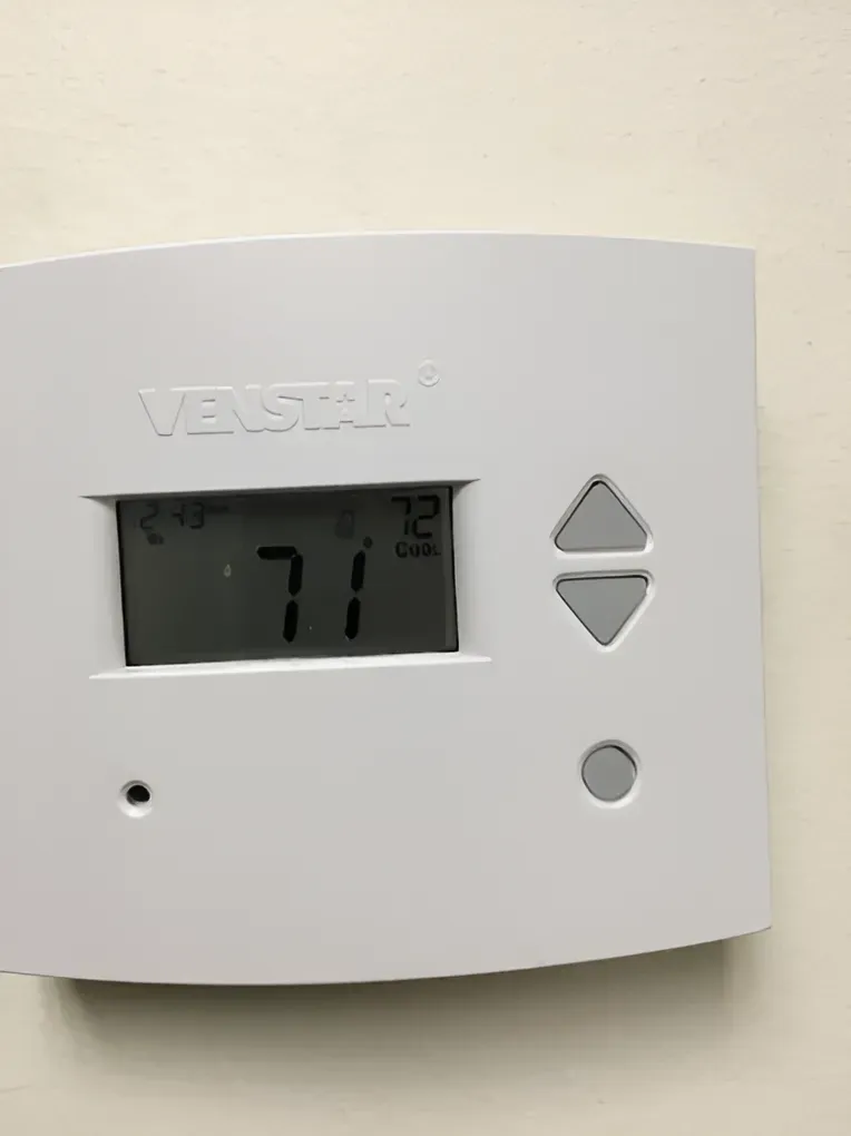 White Venstar thermostat displaying 71 degrees; currently set to 72 degrees.