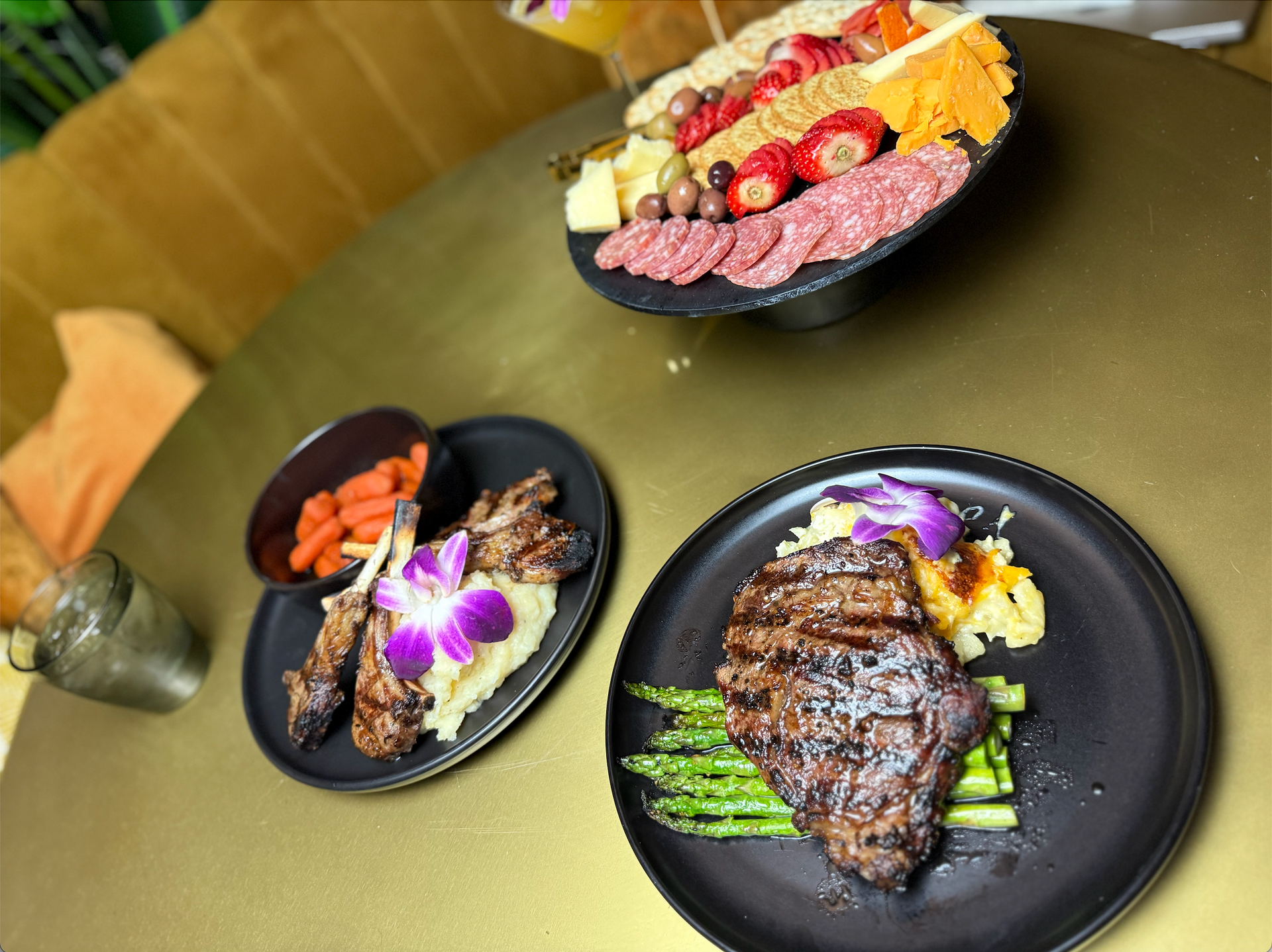 A table topped with plates of food and a martini glass.