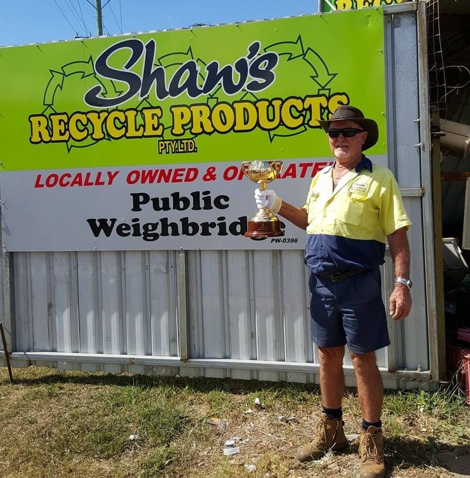 Guy Beside The Banner Of Shaw's Recycle Products - The Scrap Metal Recyclers in Bundaberg, QLD