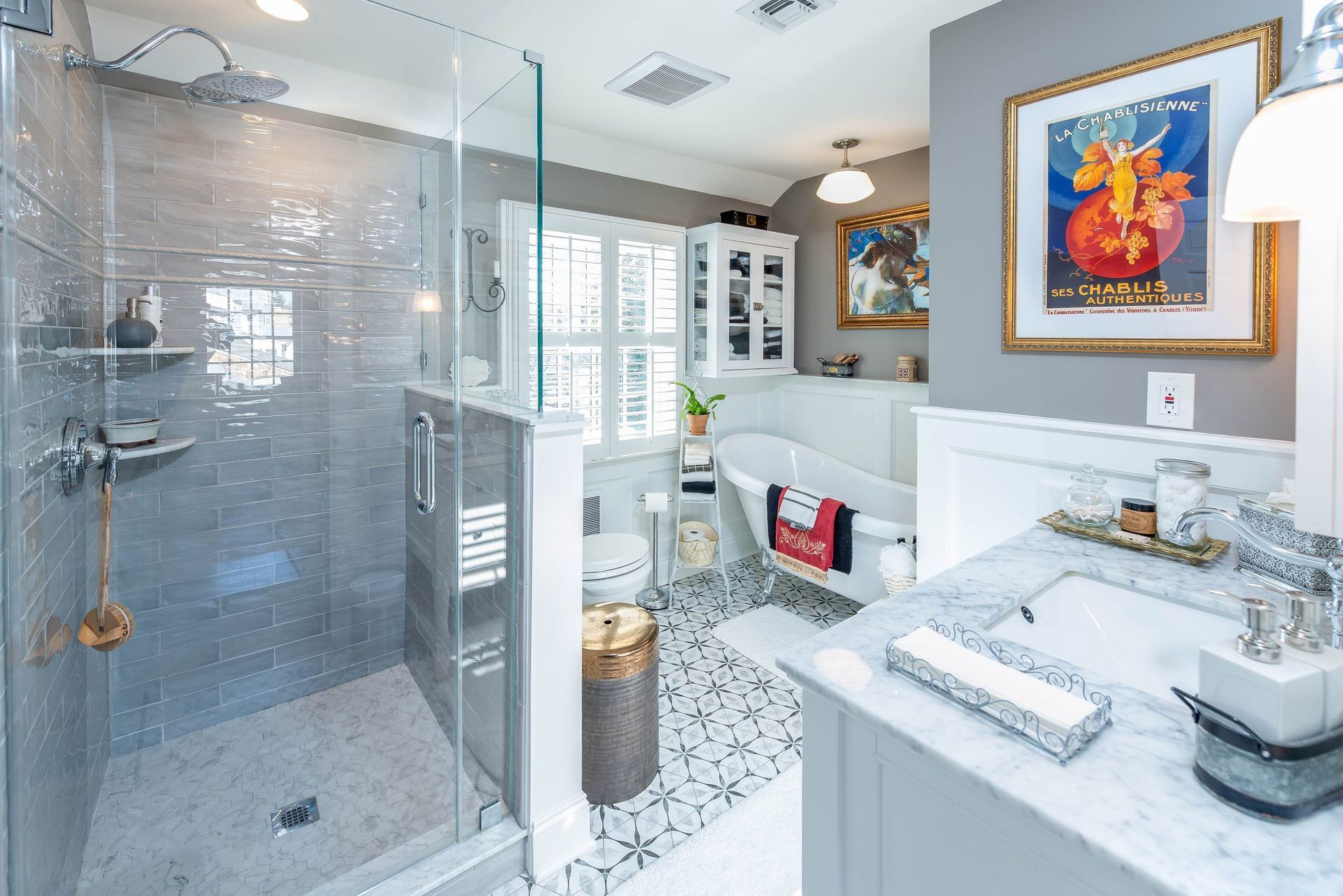 A bathroom with a walk in shower, sink, and bathtub.
