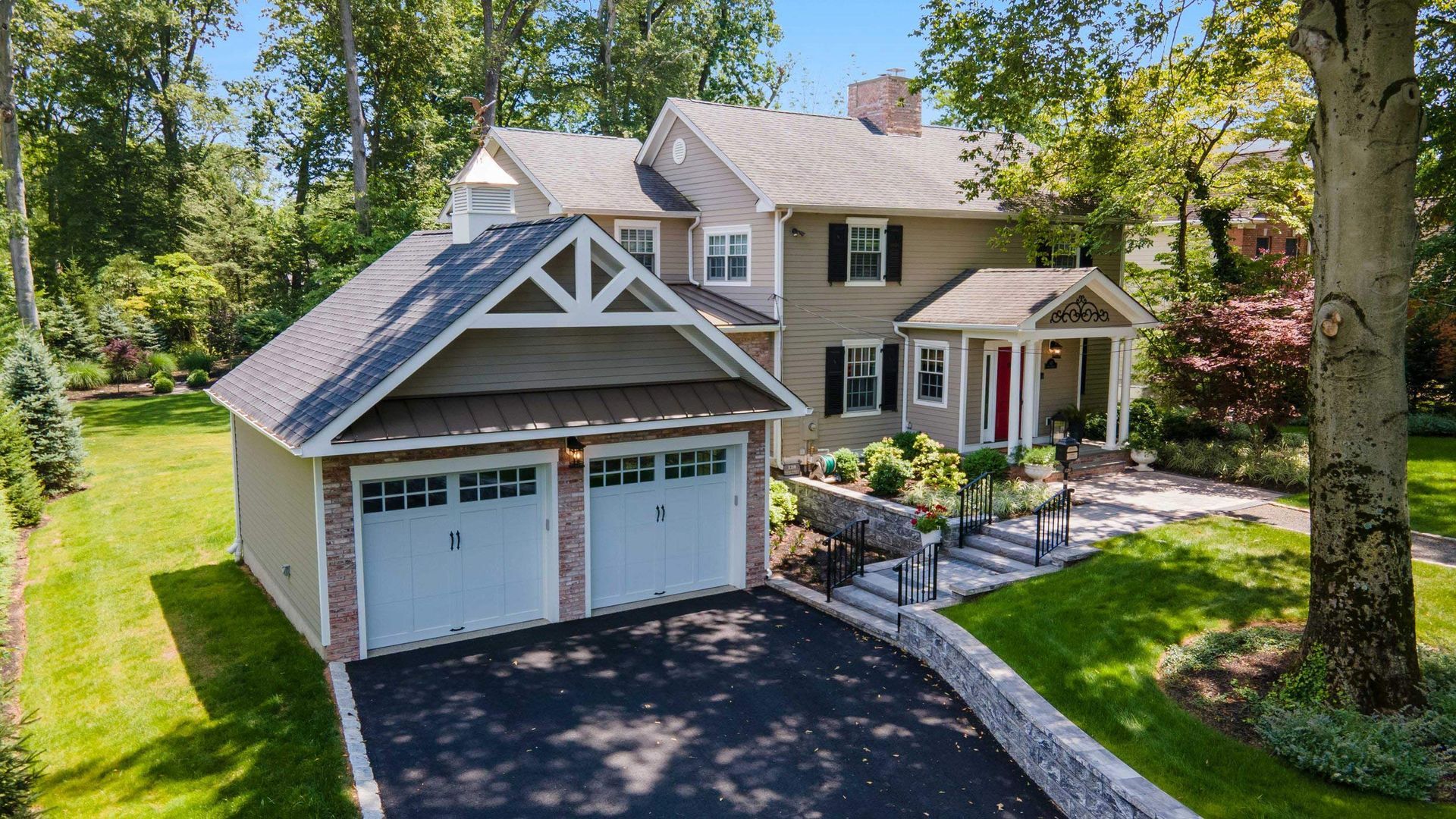 An aerial view of a house with two garage doors and a driveway.