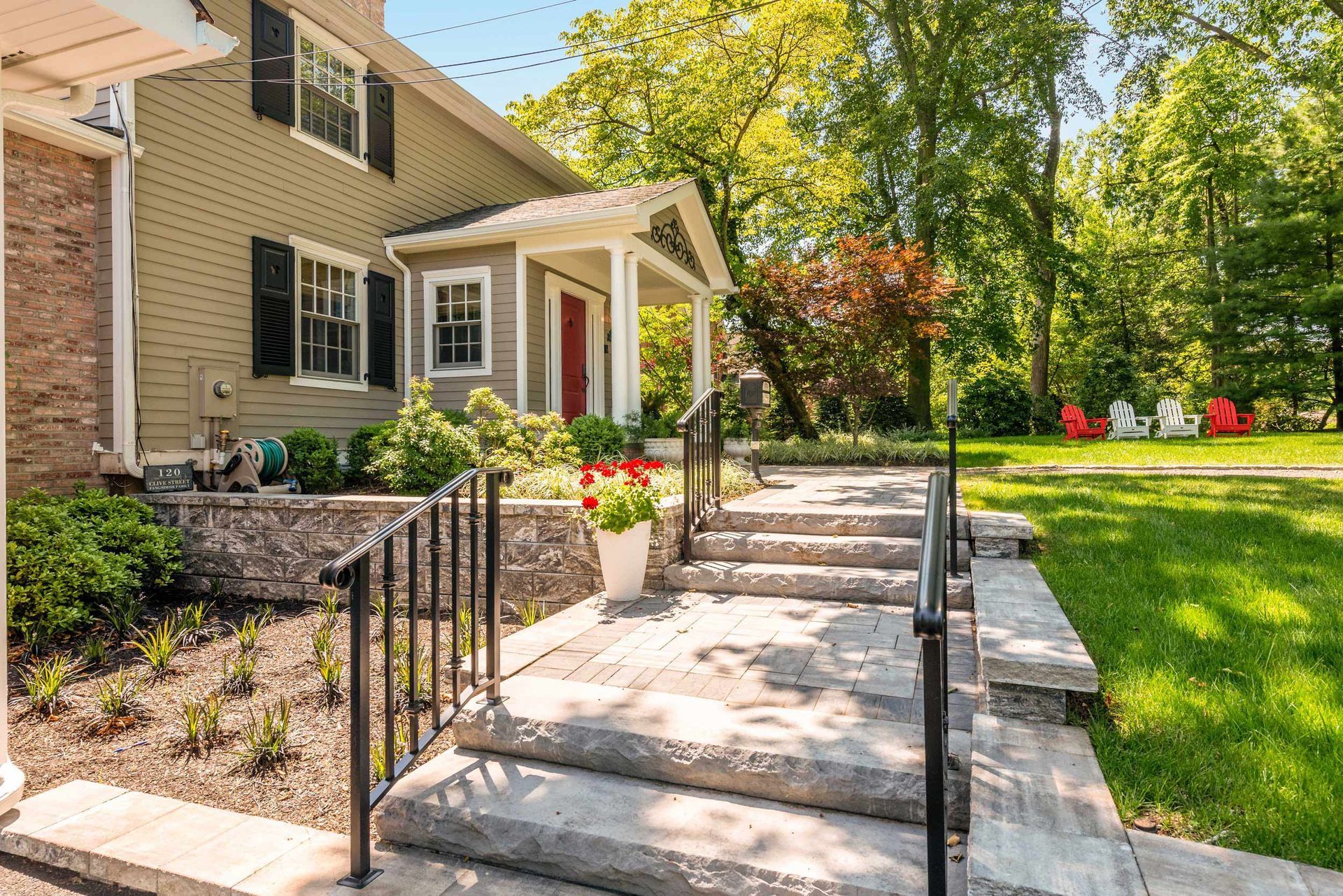 There are stairs leading up to the front of a house.