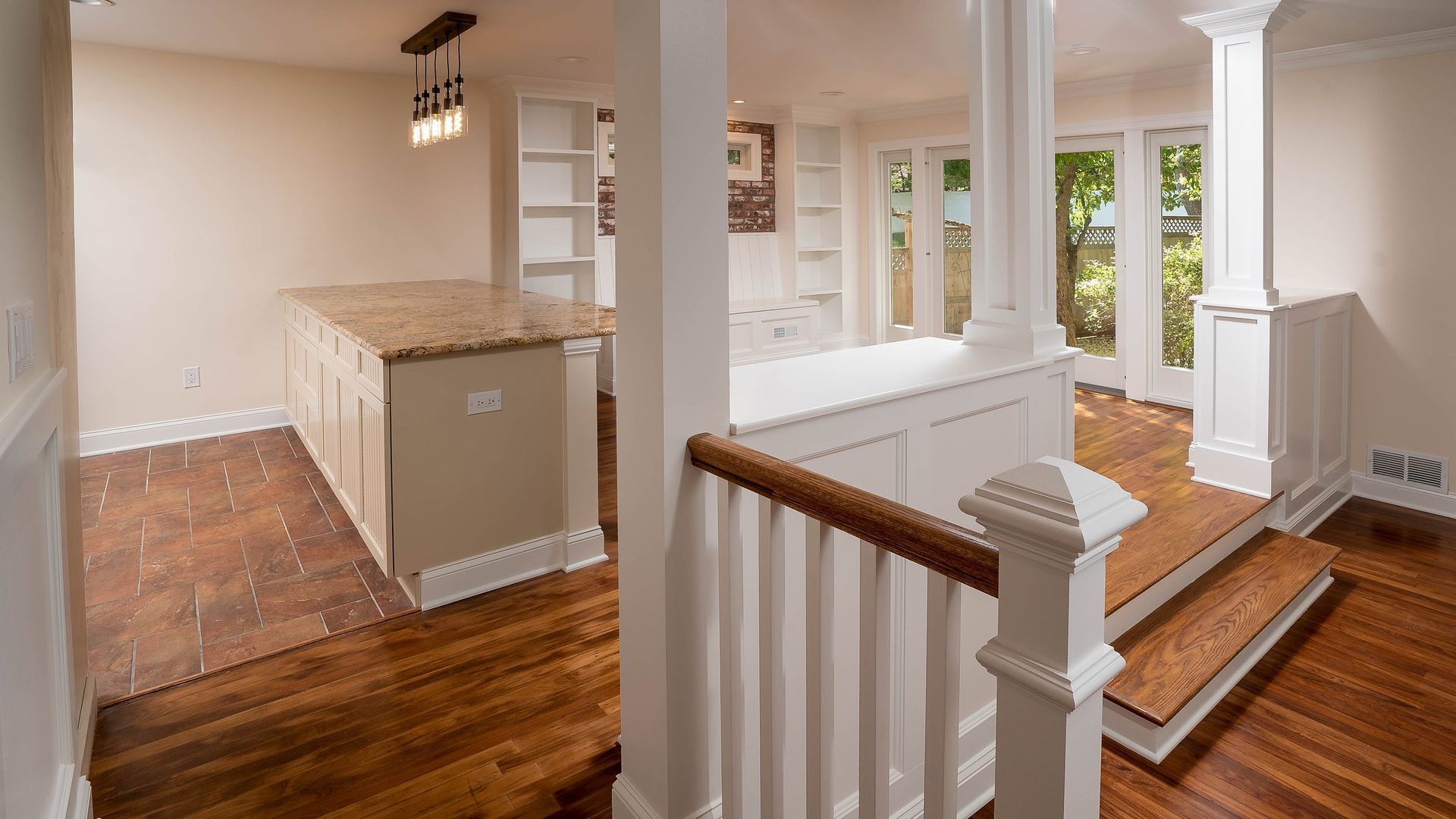 A staircase leading up to a kitchen in a house.